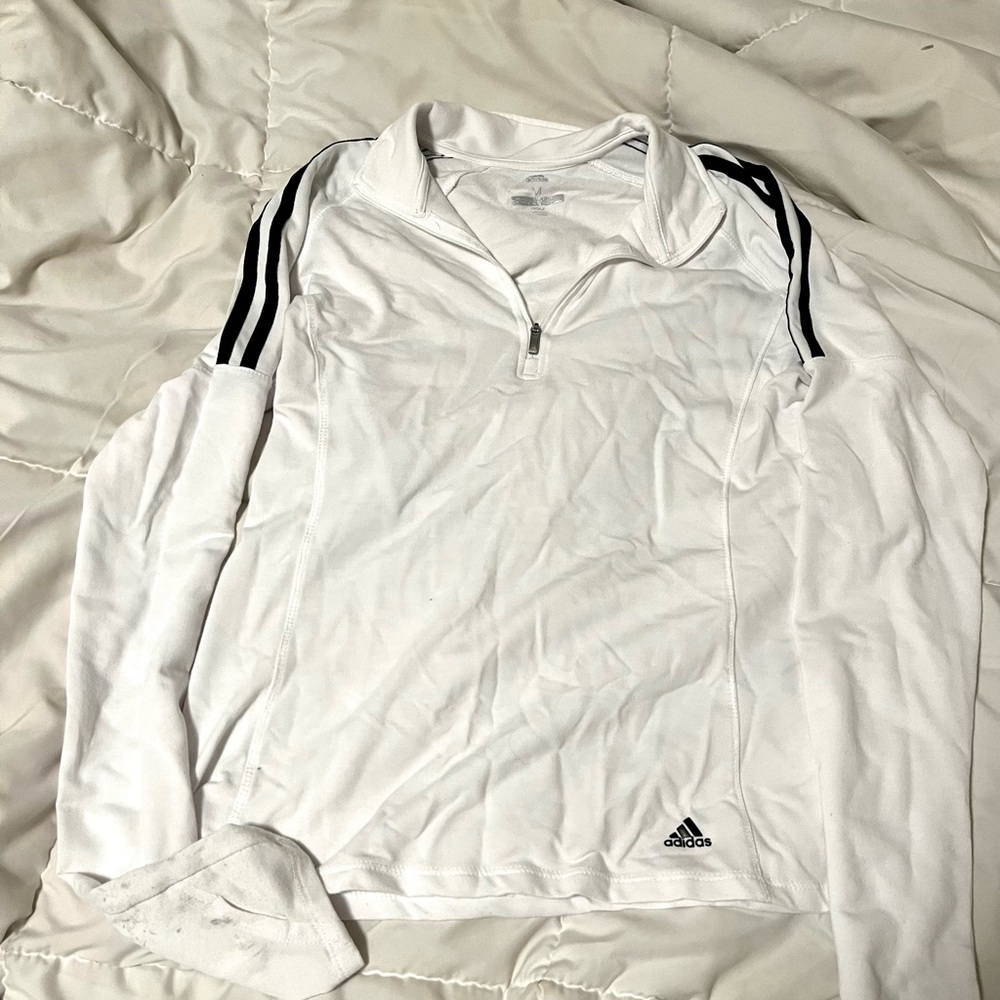This is an adidas jacket with thumb holes on the sleeves and a collared neckline
